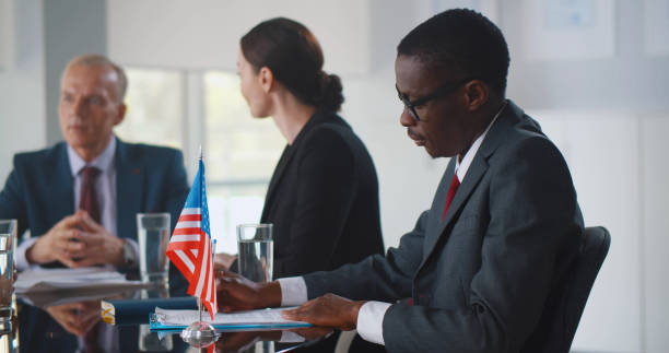 istock Interracial partners working and discussing together business plan at meeting in office 1491490597