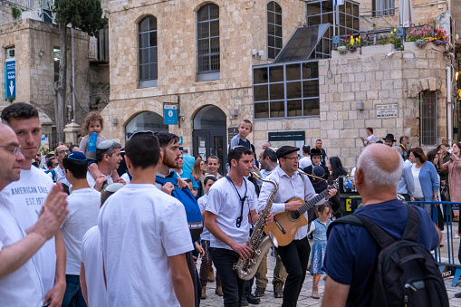 Jerusalem, Israel, May 8, 2019: Young israeli jewish teenagers, girls going with Israeli flag at Independence Day, in Jerusalem, Israel
