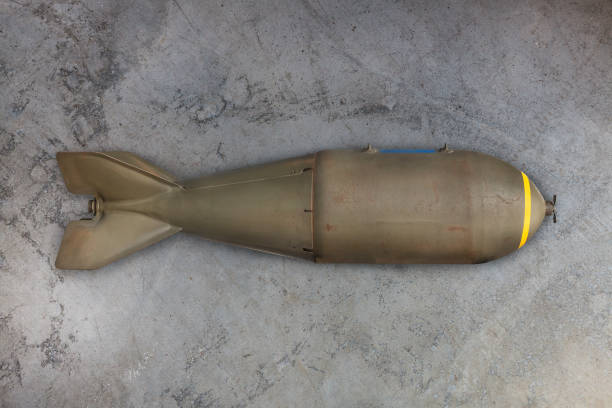 Military missile bomb Ancient military missile bomb in front of an eroded grey background bomb stock pictures, royalty-free photos & images