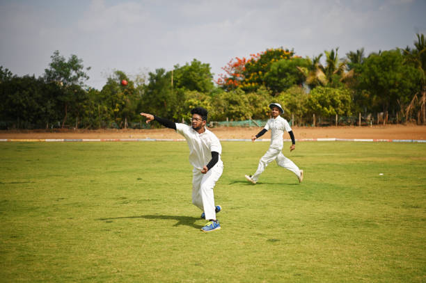 istock Fielder fielding the ball and throwing it back during a cricket match 1491495047