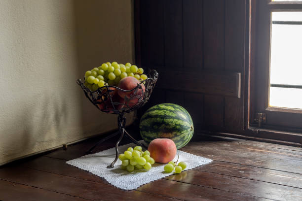 Still life with fruit in a vase on the windowsill
