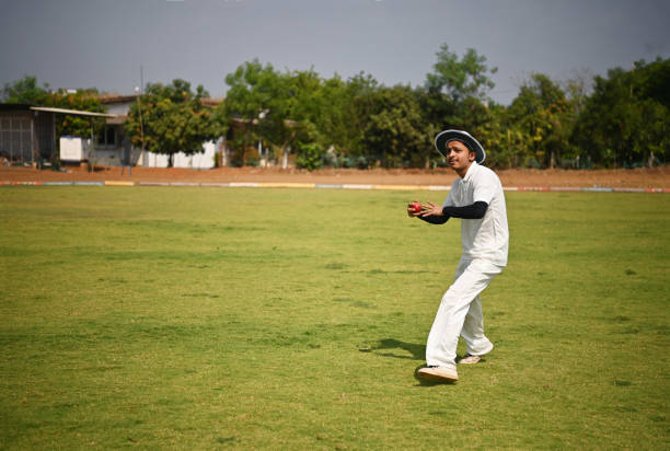 istock Fielder fielding the ball and throwing it back during a cricket match 1491495117