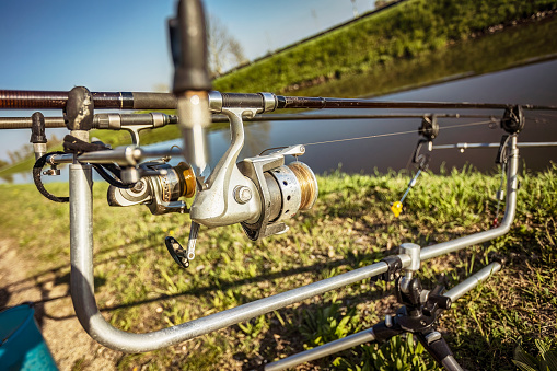 Close-up photo of a fishing reel and rod, perfect for carp fishing enthusiasts.