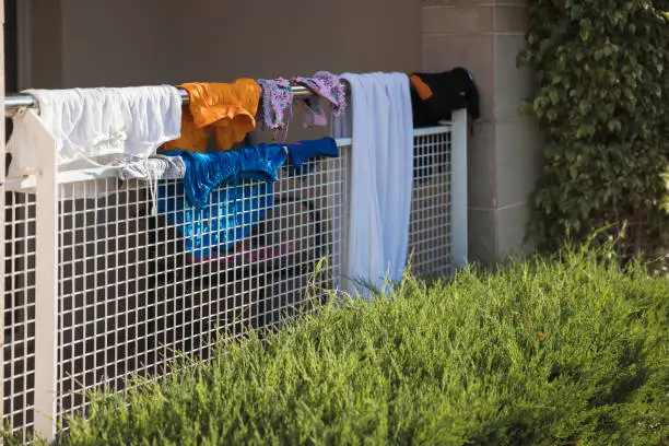Photo of Wet laundry drying on a fence