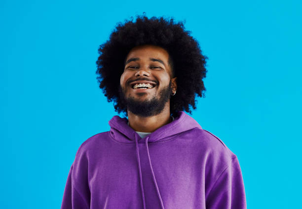 istock Young black man with a afro hairstyle looking into the camera whilst looking up, smiling with copy space, stock photo 1491503175