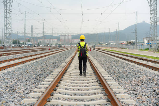 istock The silhouette of railway workers on the tracks 1491504774