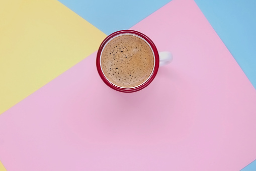 Cup of coffee on colored background