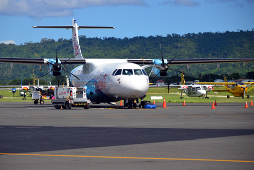 Port Vila, Vanuatu: front view of Air Vanuatu ATR 72-600 aircraft (72-212A, registration YJ-AV73, MSN 1358) - being serviced at Bauerfield  / Port Vila International Airport (VLI), hub for Vanuatu's flag carrier airline, Air Vanuatu
