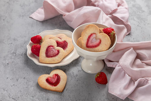 Heart-Shaped Strawberry Shortbread Cookies with Dried Strawberries. Top view flat lay background