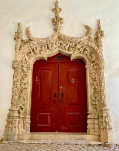 istock Red door with elaborate carved stone frame 1491507777