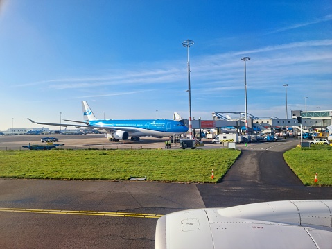 Amsterdam Airport Schiphol with several aircrafts at the gates. The image was captured during spring season.