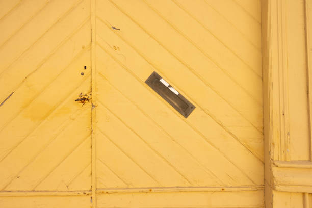 istock Angled letter box on a yellow port door.. 1491511536