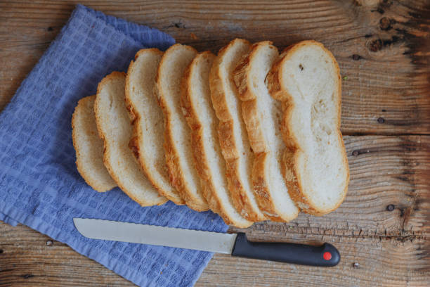 istock Sliced freshly baked whole grain sourdough bread on a rustic wooden board, top view 1491512821