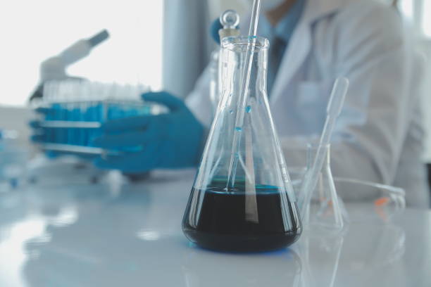 istock biochemical research scientist team working with microscope for coronavirus vaccine development in pharmaceutical research labolatory, selective focus 1491512859