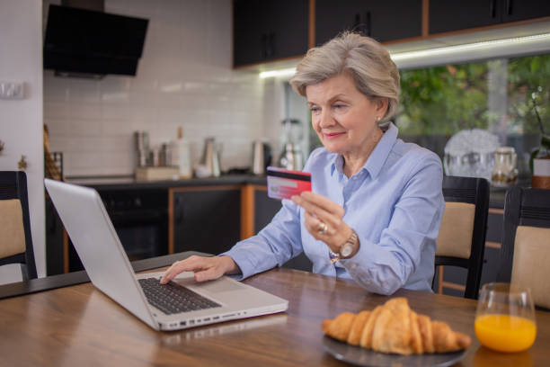 istock Happy senior customer enjoys shopping online 1491513478