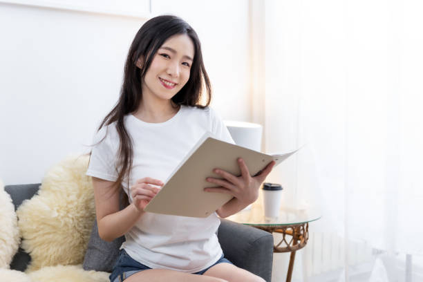 istock Female with clipboard working sitting on couch in office 1491516234