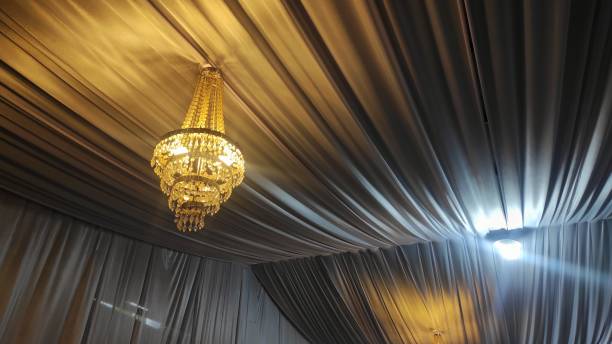 istock Yellow lamped chandelier next to white lamp on the ceiling light grey decorations 1491516914