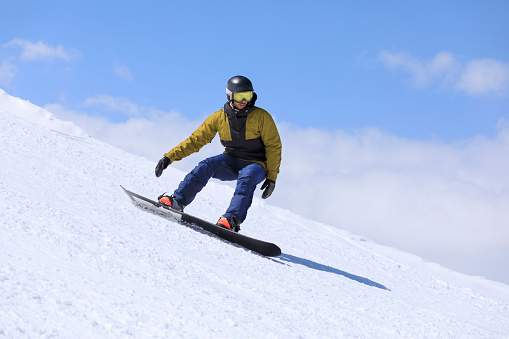 Snowboarding.  Young man snowboarder on the mountain ski slope.