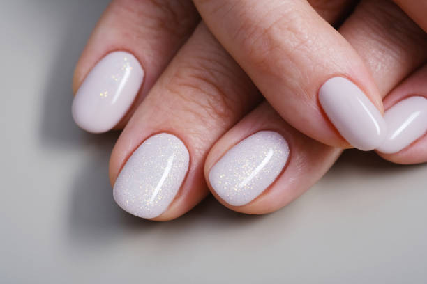 istock Care for sensuality female hands on a gray background. Top view. Macro 1491523137