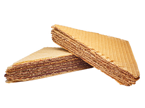 Two triangular wafer cake sliced stacked next to each other studio shot isolated on white background