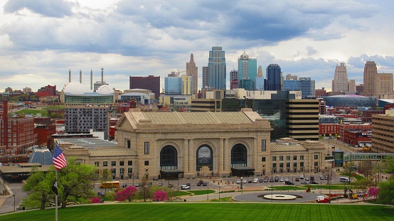 This is a wide shot of downtown Kansas City, Missouri from atop of the War Memorial overlook. You can see the iconic Union Station and buildings/hotels in the backdrop.