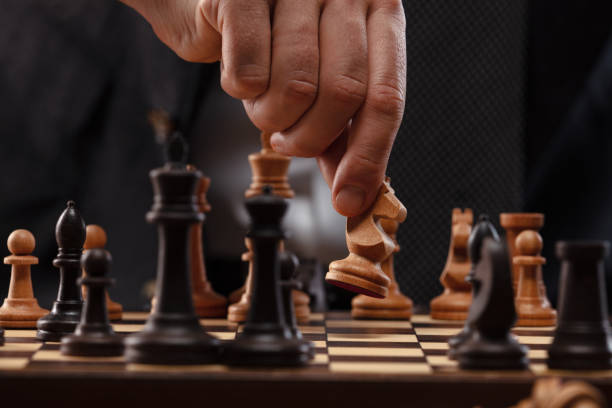 istock Mans hand and chess pieces on the board. 1491532208