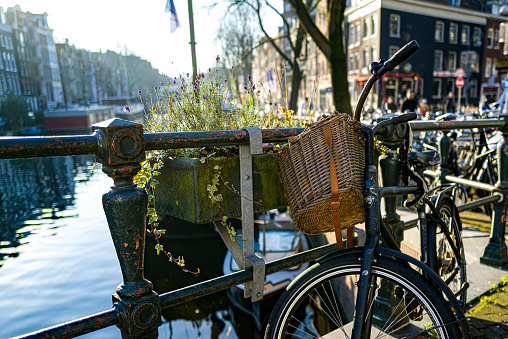 Netherlands. Summer day in Amsterdam. Several bicycles are parked in front of the dancing facades of typical Dutch townhouses