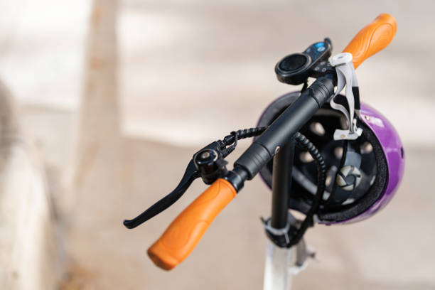 istock Purple helmet hanging on a electric push scooter 1491532695