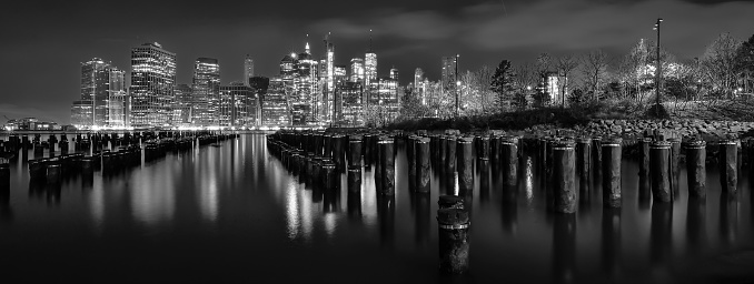 Night time reflections of Manhattan captured from Old Pier 1, Brooklyn Bridge Park in B/W.