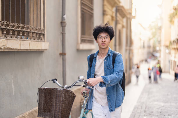 istock Young businessman Chinese ethnicity, commuting through city by bicycle 1491534044