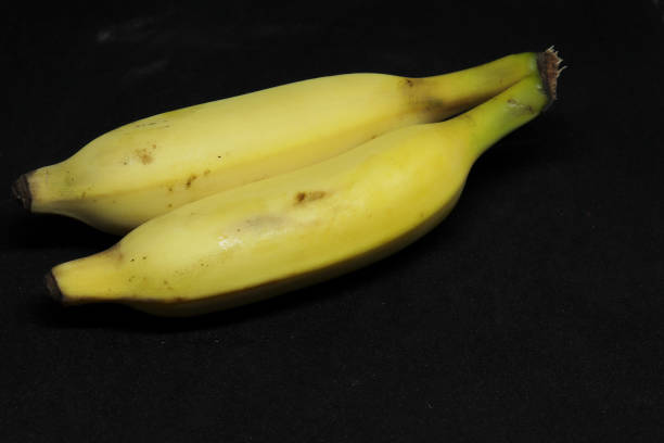 istock yellow banana. with black background 1491536113