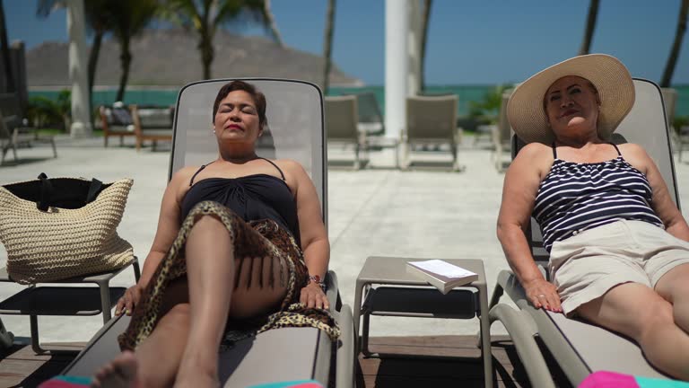 Senior friends taking the sun at a luxury hotel outdoors