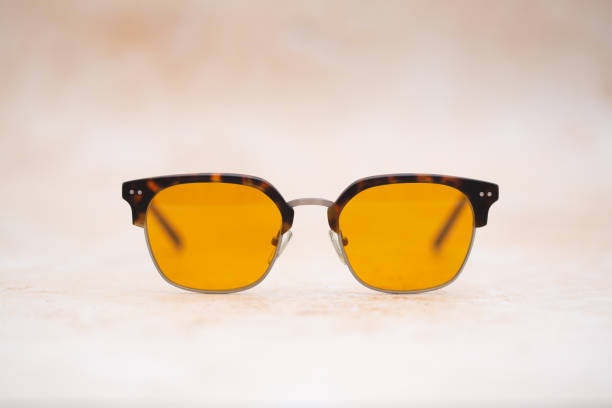 istock Yellow Tinted Sunglasses on Sandstone 1491536915