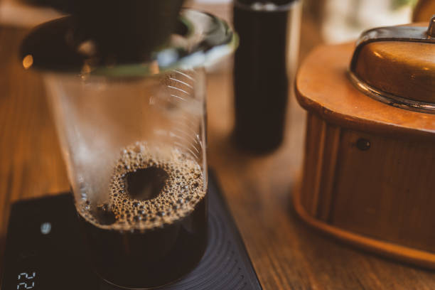 istock Professional hipster barista making drip brewing, filtered coffee or pour over coffee with hot water and filter paper in coffee shop cafe, black vintage tone of fresh caffeine aroma beverage 1491541116