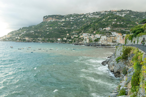 Minori is a town and a comune in the province of Salerno, in the Campania region, as a part of the Amalfi Coast, it was declared a World Heritage site by UNESCO on September 4, 2021. Beach during sea storm.
