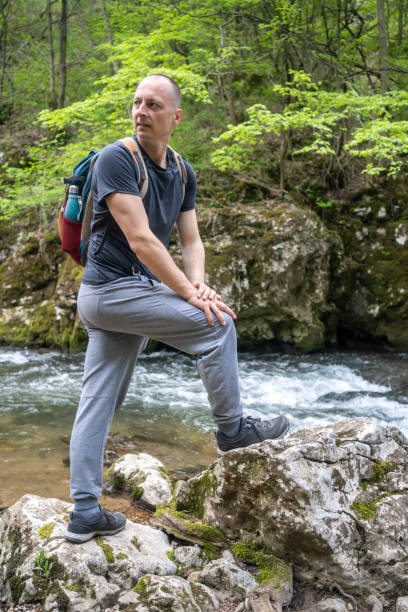 istock A man standing at waterfall travel concept 1491544011