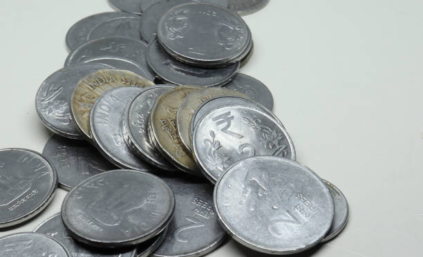 istock Pile of Indian Rupee Coins. On a white background 1491546623