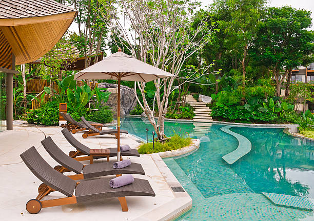 istock Beach chairs and umbrella side swimming pool 149154810