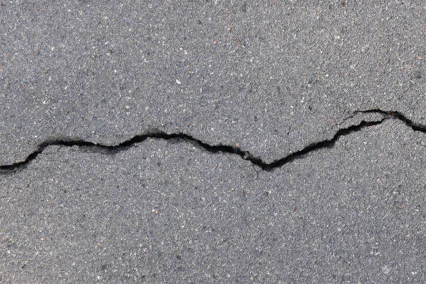 close-up asphalt road with large long crack - crevice imagens e fotografias de stock