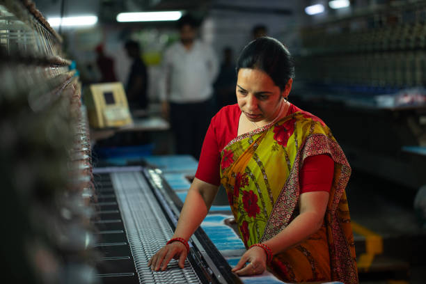 istock Female worker operating machinery in textile factory 1491549653