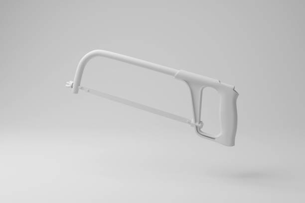 White hacksaw floating in mid air with shadow on white background in monochrome. Illustration of the concept of construction work and metal cutting