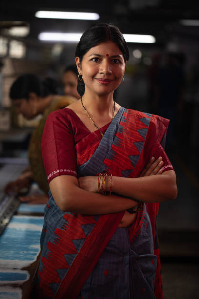 istock Confident manager standing against coworkers in factory 1491551291