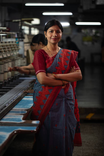istock Confident manager standing against coworkers in factory 1491551318