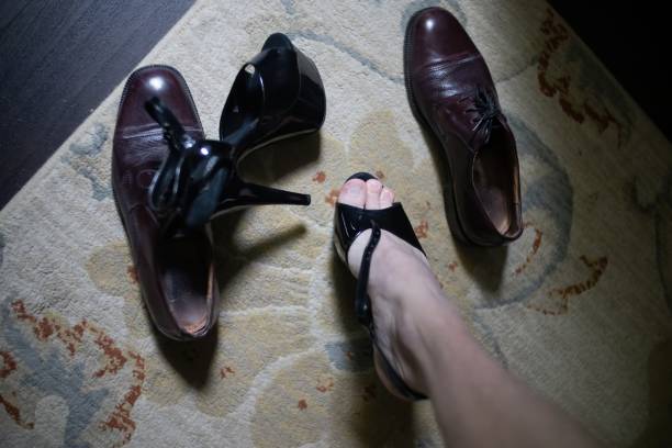 istock man choosing between men's shoes or women's high heels 1491551391
