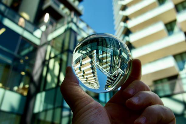 istock Hand holding crystal ball against modern buildings 1491551631