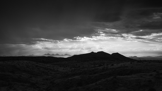 Silhouette of distant McDowell Mountains through monsoon storm clouds