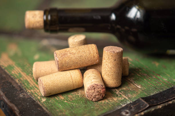 istock Corks from wine bottles on a wooden table. 1491559288