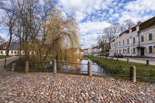 Kuldiga, Latvia - April 10, 2023: The bridge over the river Aleksupite in the small Latvian town Kuldiga