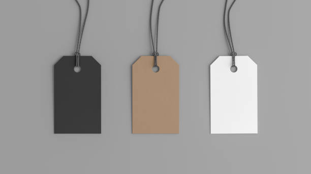 istock White, cardboard, black tags mockup on gray background. View directly above 1491560775