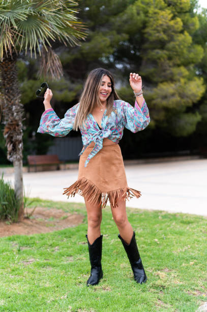 istock Beauty woman dancing happily on a park 1491560816